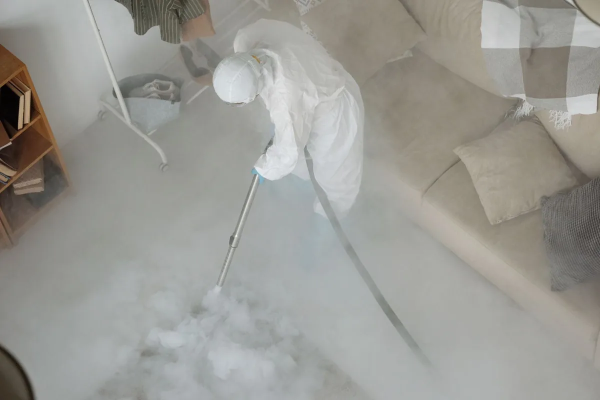 Biohazard cleanup technician in protective equipment, Quinebaug, CT